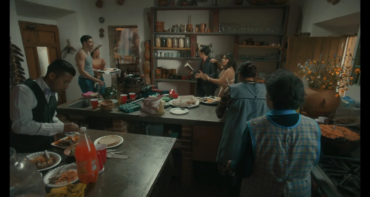 National Family (2023) movie still: wide — A rustic kitchen with open shelves stocked with jars and ceramic pottery.
