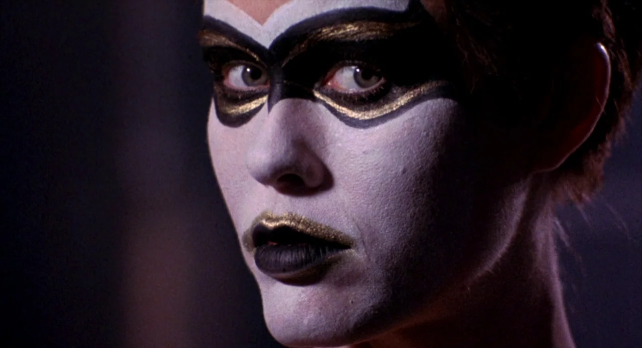 To Live and Die in L.A. (1985) movie still: closeup — A close-up view shows a person wearing heavy white face makeup and theatrical eye paint. The…