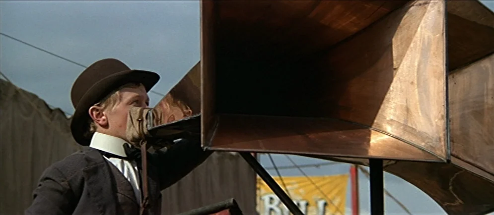 Buffalo Bill and the Indians, or Sitting Bull’s History Lesson (1976) movie still: medium — A fairground setting under an overcast sky features a…