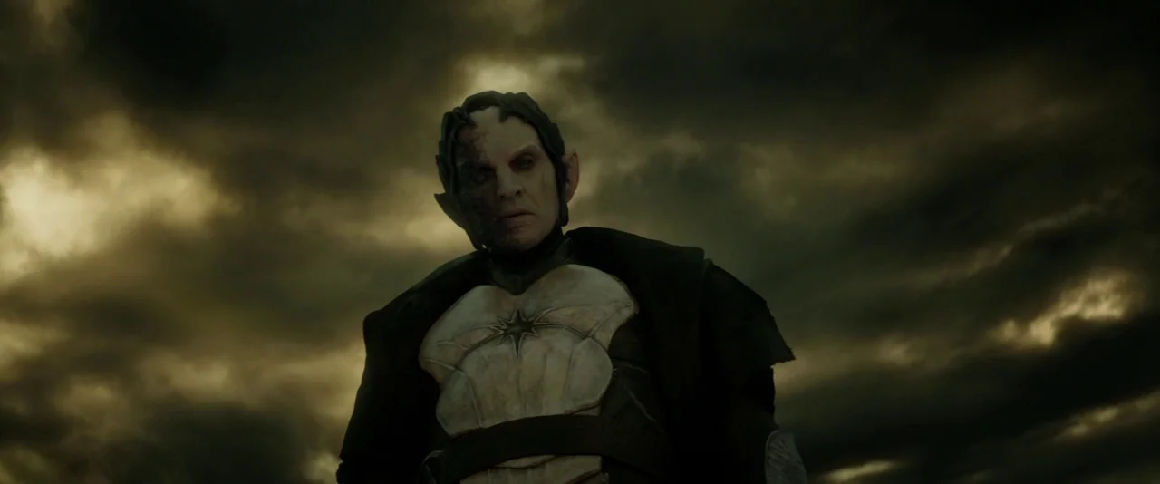 Thor: The Dark World (2013) movie still: medium — A figure stands against a dark, cloudy, and turbulent sky. The character wears light-colored armor…