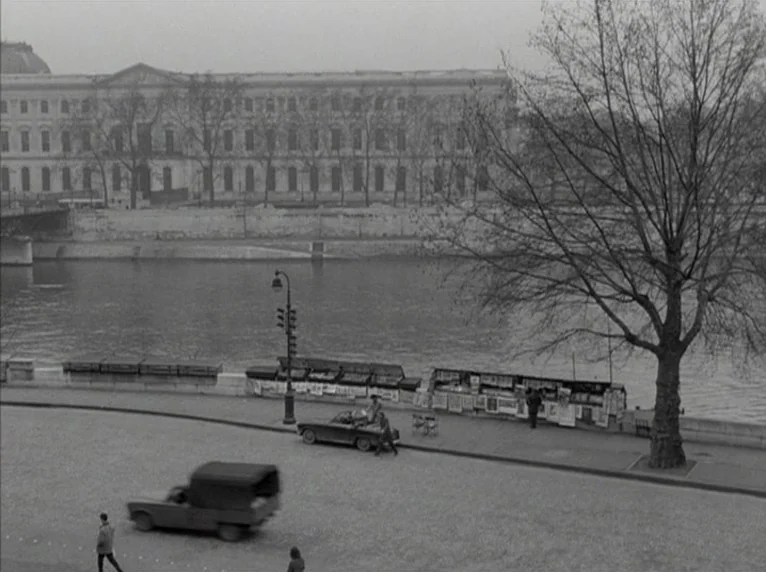 Band of Outsiders (Bande à part) (1964) movie still: wide — The Seine riverbank in Paris features historic stone architecture across the water. A…