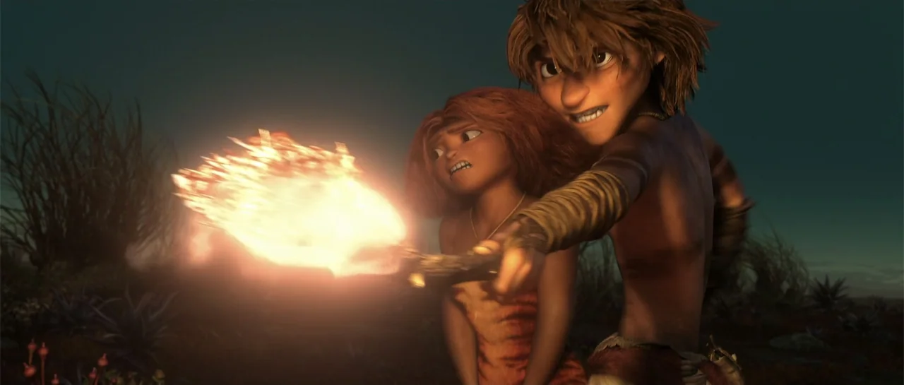 The Croods (2013) movie still: medium — An open dark wilderness at night features sparse desert plants and rocky ground. A young man points a…
