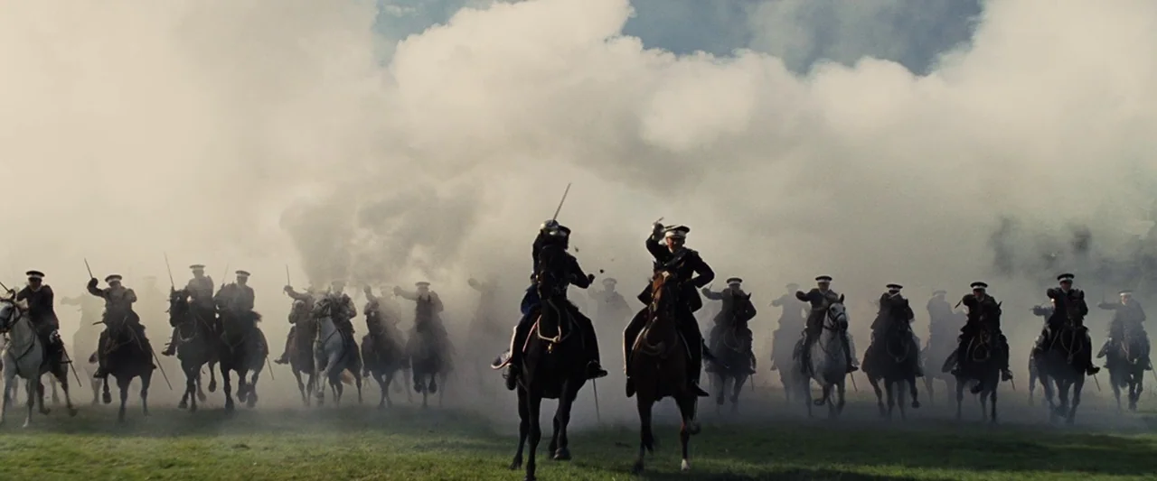 War Horse (2011) movie still: wide — A field filled with billowing smoke hides the distance behind a line of cavalry. Numerous soldiers ride horses…