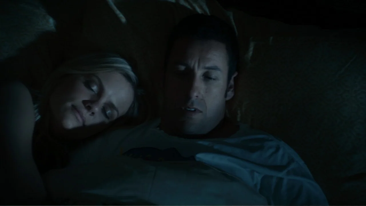 Just Go with It (2011) movie still: medium — A dimly lit bedroom features two people resting in bed at night. The man and woman are lying together…