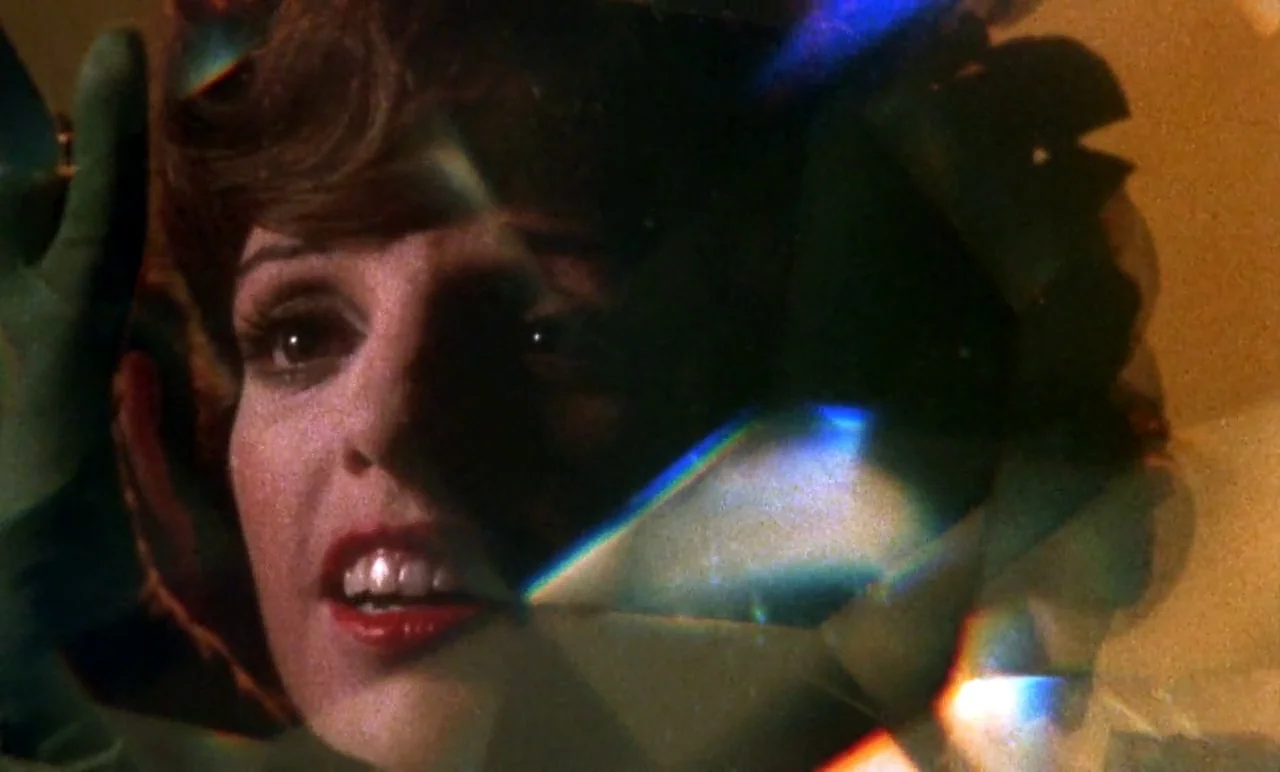 New York, New York (1977) movie still: closeup — A close-up view shows a woman with red lips partially obscured by prismatic light artifacts. She…