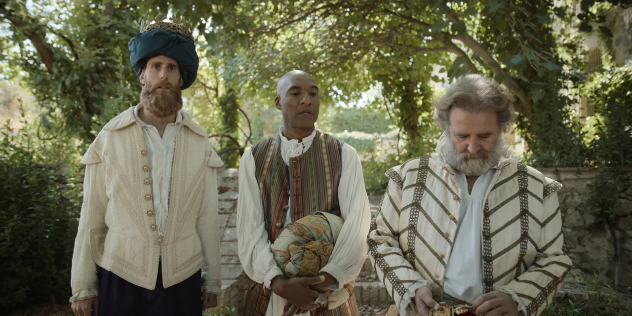 The Three Wise Men: The Truth (2022) movie still: medium — A stone courtyard is shaded by overhead leafy trees and overgrown vines. Three men…