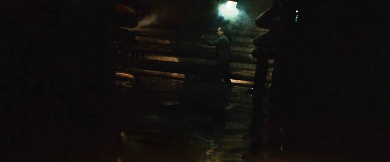 Mirrors (2008) movie still: wide — A subterranean room with horizontal metal pipes lining the damp walls. A man moves through the shadows in the…