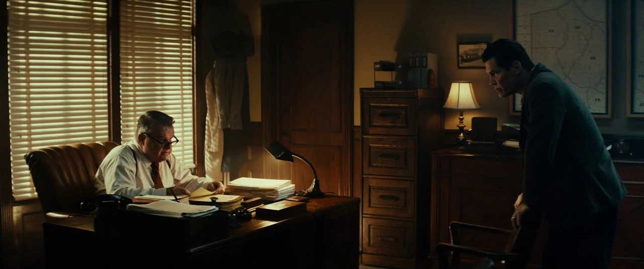Gangster Squad (2013) movie still: wide — A dark, wood-paneled office from the 1940s contains filing cabinets, maps, and paper stacks. An older man…
