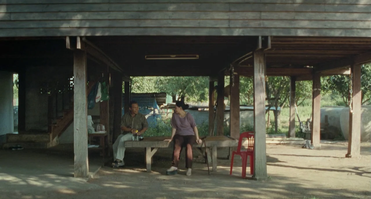 Uncle Boonme Who Can Recall His Past Lives (2010) movie still: wide — The space beneath a wooden stilt house provides a shaded area with dirt…
