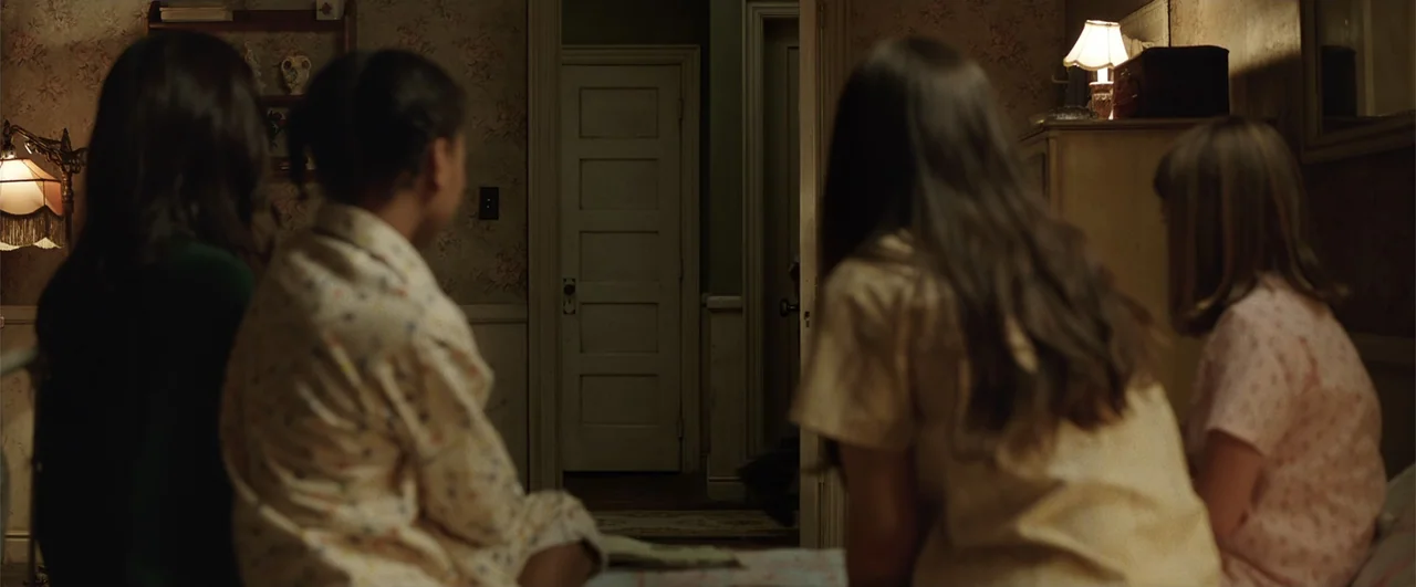 Annabelle: Creation (2017) movie still: medium — A dimly lit bedroom features floral wallpaper and a doorway leading into a hallway. Four children…