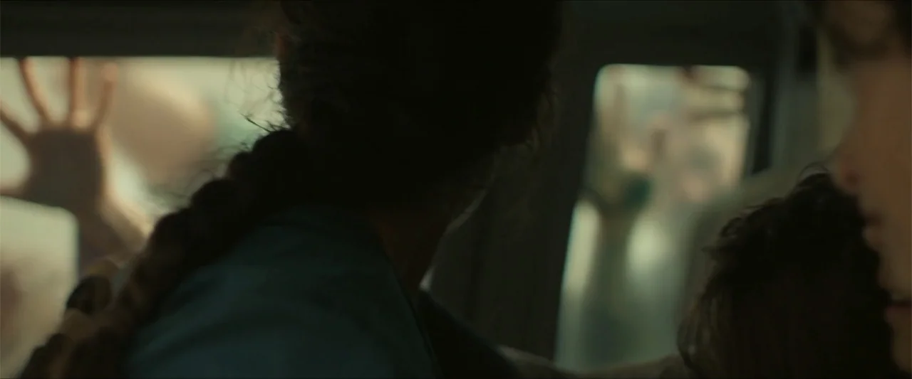 Apocalypse Z: The Beginning of the End (2024) movie still: medium — A close view inside a vehicle cabin with windows revealing blurred shapes…