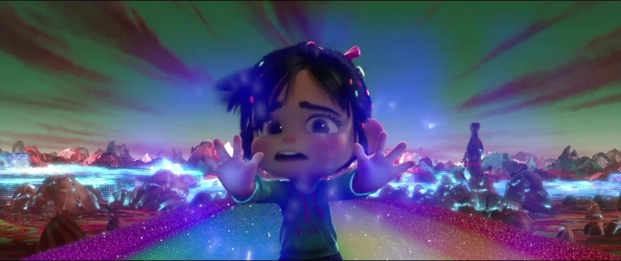 Wreck-It Ralph (2012) movie still: medium — A digital candy-textured landscape with glowing blue rivers and dark, jagged peaks. A small girl in a…