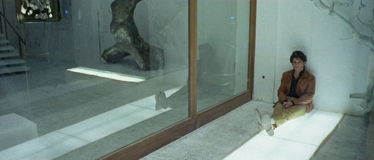 The Bird With The Crystal Plumage (1970) movie still: wide — An interior space with white marble walls and illuminated floor panels showcasing…