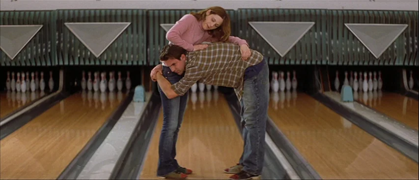 All The Real Girls (2003) movie still: fullbody — A classic bowling alley lane features polished wooden floors and rows of upright pins. A man bends…