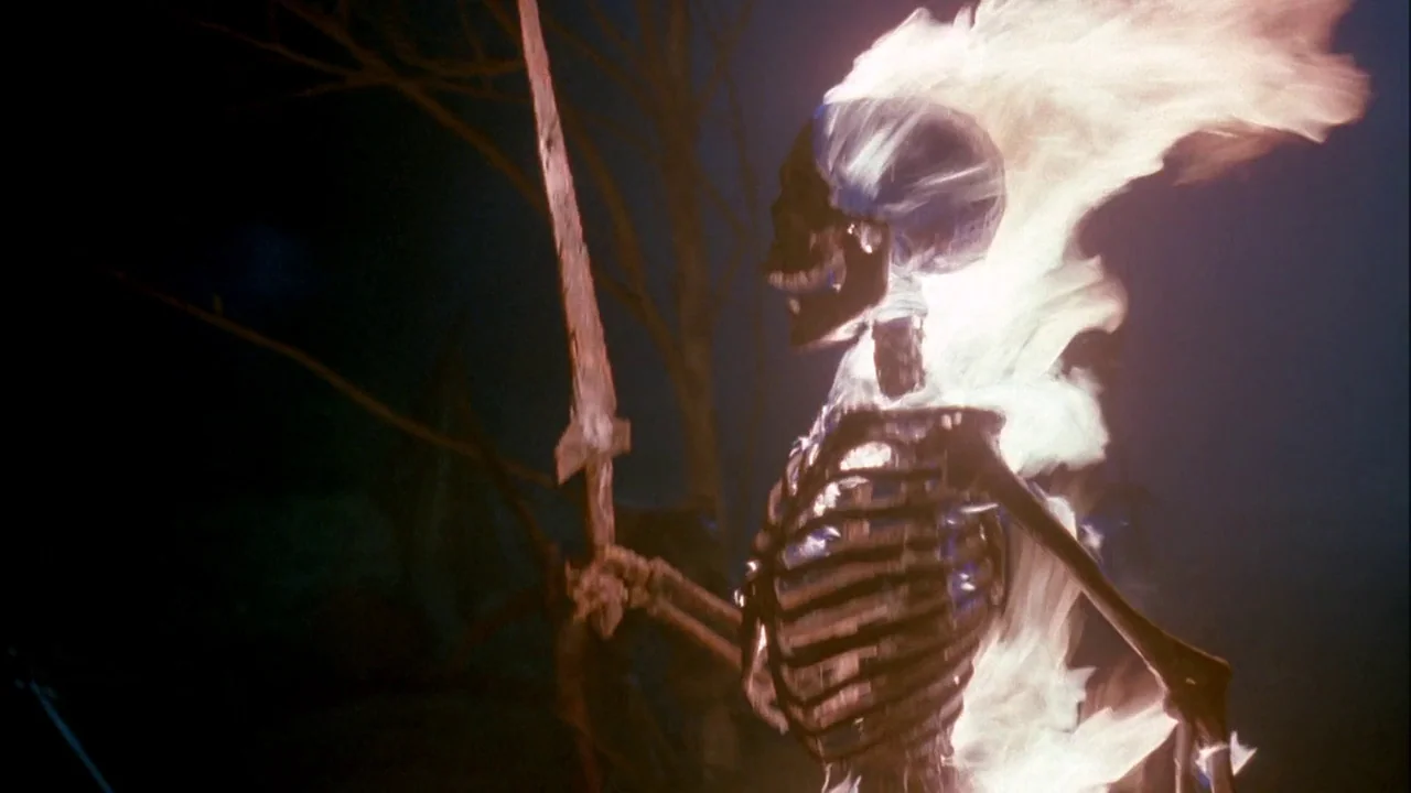 Army of Darkness (1992) movie still: medium — A skeletal figure stands in a dark environment with bare branches in the back. The skeleton is…