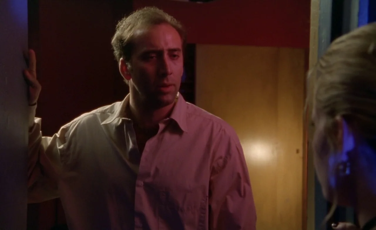 Leaving Las Vegas (1995) movie still: medium — A dimly lit interior space with a person framed within a doorway. A man looks toward the side of the…