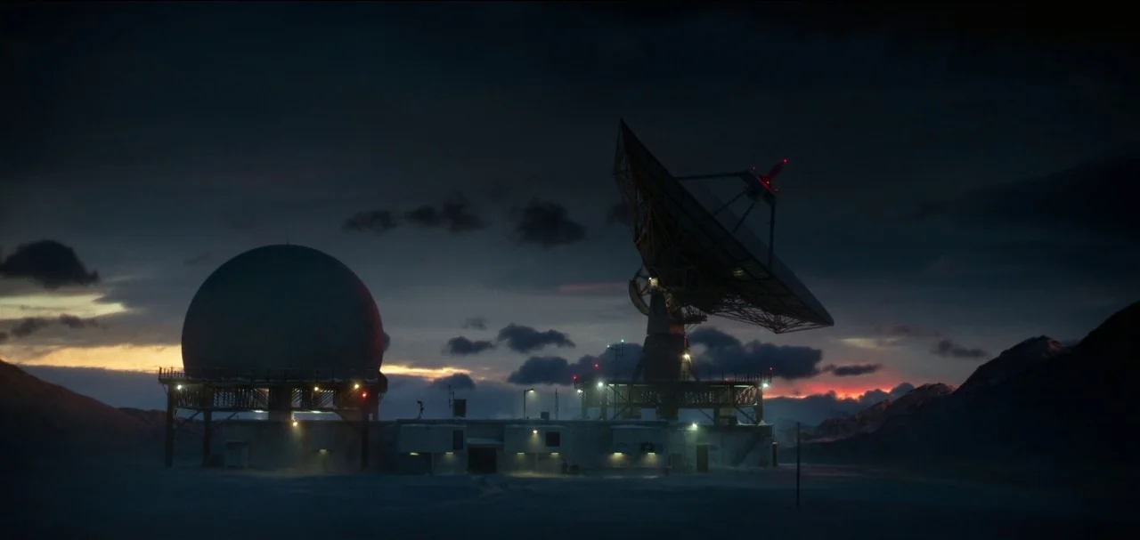 The Midnight Sky (2020) movie still: wide — A remote arctic research facility with a radome and large satellite dish at dusk. Mountains surround the…