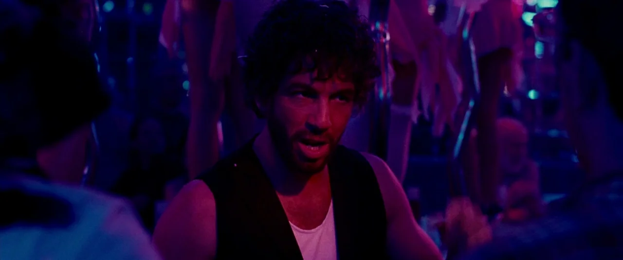 The Hangover Part II (2011) movie still: medium — A dimly lit club interior features saturated magenta and deep blue neon illumination throughout. A…
