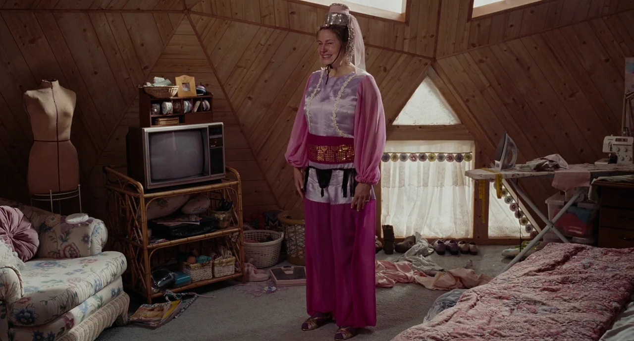 Gentlemen Broncos (2009) movie still: fullbody — A wood-paneled attic with triangular ceilings contains a television, sewing equipment, and…