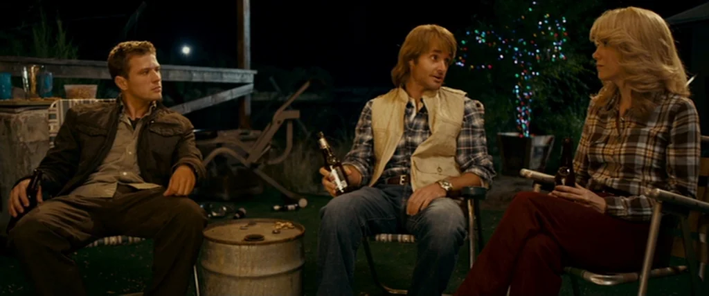 MacGruber (2010) movie still: medium — A nighttime patio space is illuminated by warm ambient lighting and colorful decorative lights. Three people…