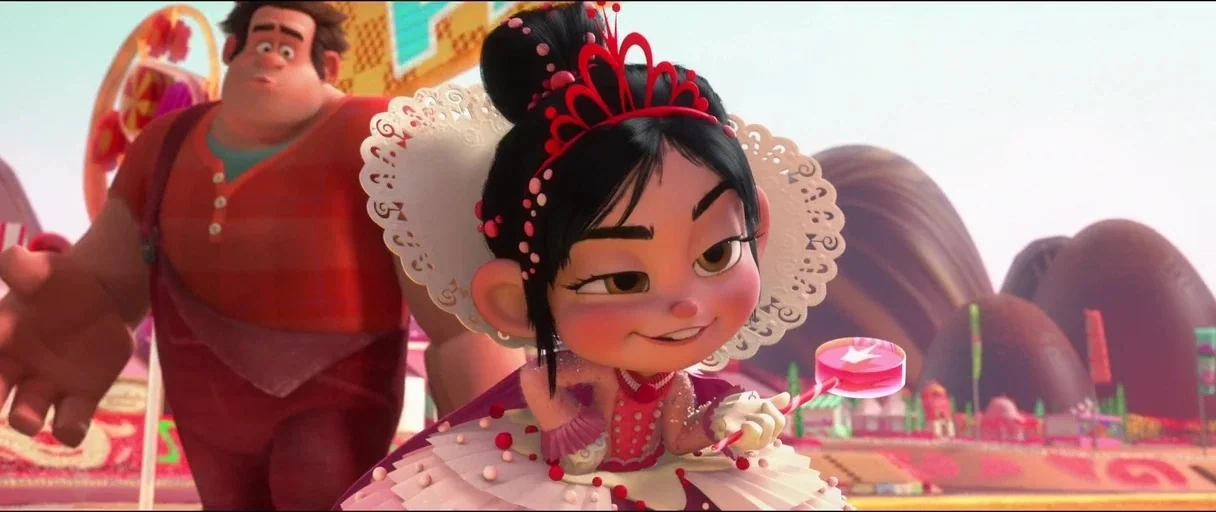 Wreck-It Ralph (2012) movie still: medium — A landscape made of confectionery textures features rolling chocolate hills and candy-themed structures.…