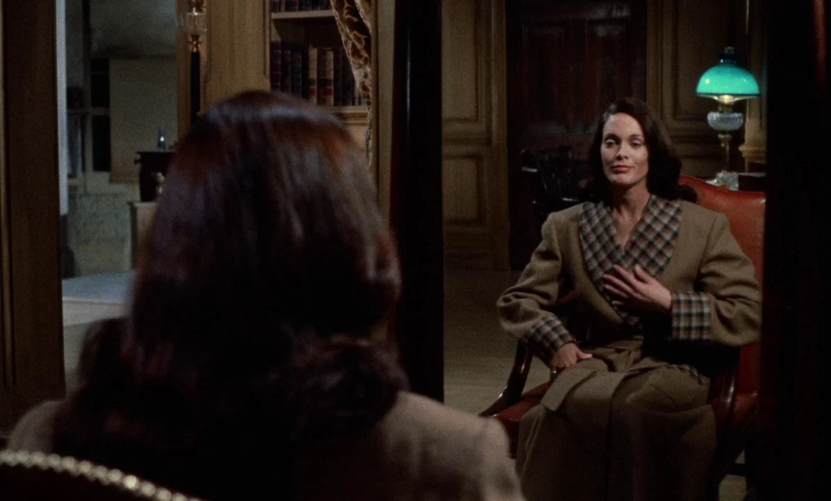 Dr Jekyll & Sister Hyde (1971) movie still: medium — A dark study features wooden paneled walls and bookshelves filled with volumes. A woman wearing…