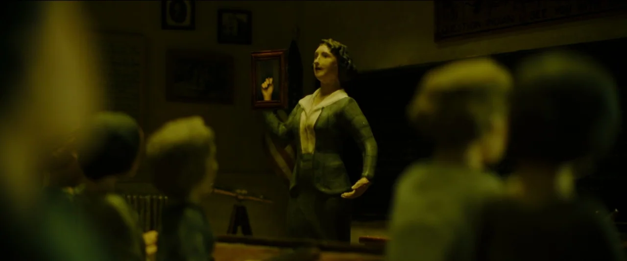 Wonderstruck (2017) movie still: medium — A dark classroom with clay figures features a teacher standing at the front. She holds a small framed…