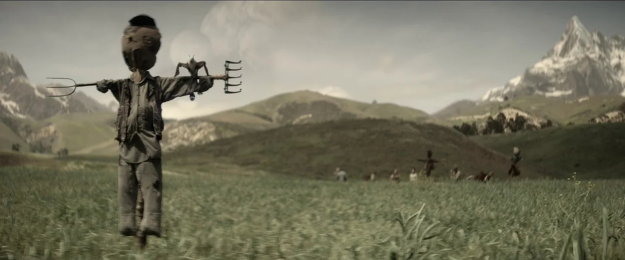 Rebel Moon – Part One: A Child of Fire (2023) movie still: wide — A vast, rolling agricultural landscape stretches toward rugged, snow-capped…