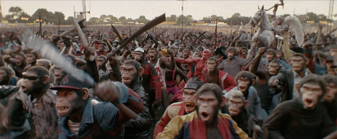 Better Man (2024) movie still: wide — A vast crowd of chimpanzees in a sports stadium holding assorted makeshift weapons. The group runs forward…
