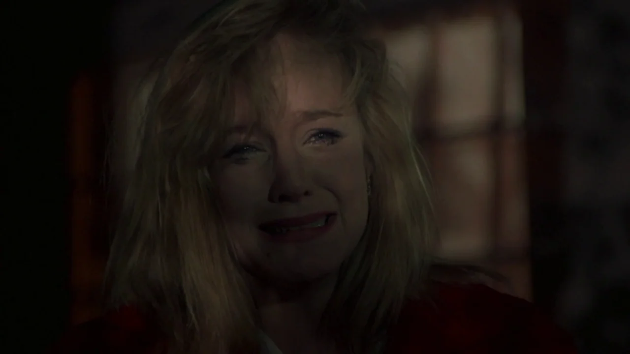 Friday the 13th Part VI: Jason Lives (1986) movie still: A raw and intimate closeup of a distraught woman in a darkened room at night. The soft,…