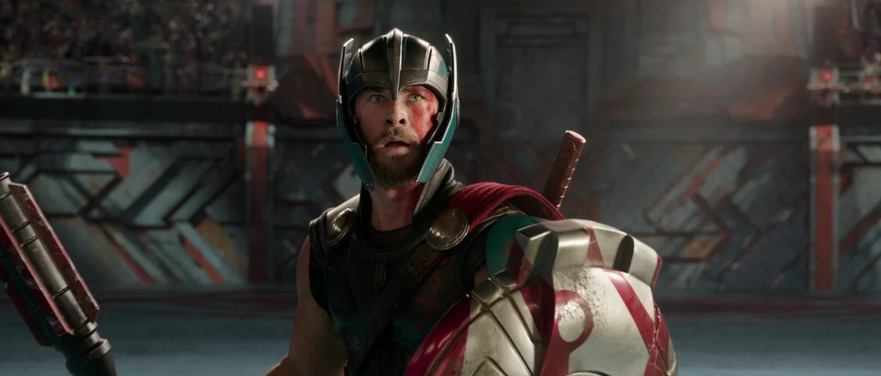 Thor: Ragnarok (2017) movie still: medium — A metal-walled gladiatorial arena features industrial textures and tiered seating for spectators in…
