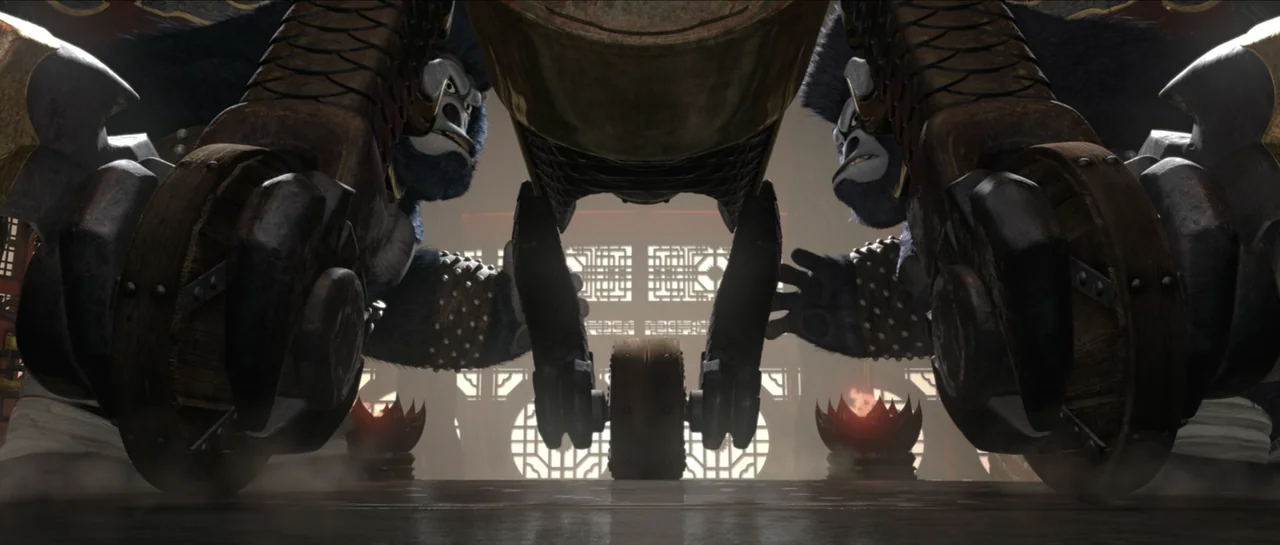 Kung Fu Panda 2 (2011) movie still: fullbody — An interior stone temple hall with wooden screen doors and lit floor-level torches. Two large dark…