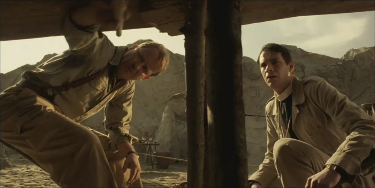 Exorcist: The Beginning (2004) movie still: medium — An arid archaeological excavation site features rocky terrain and a wooden support structure…