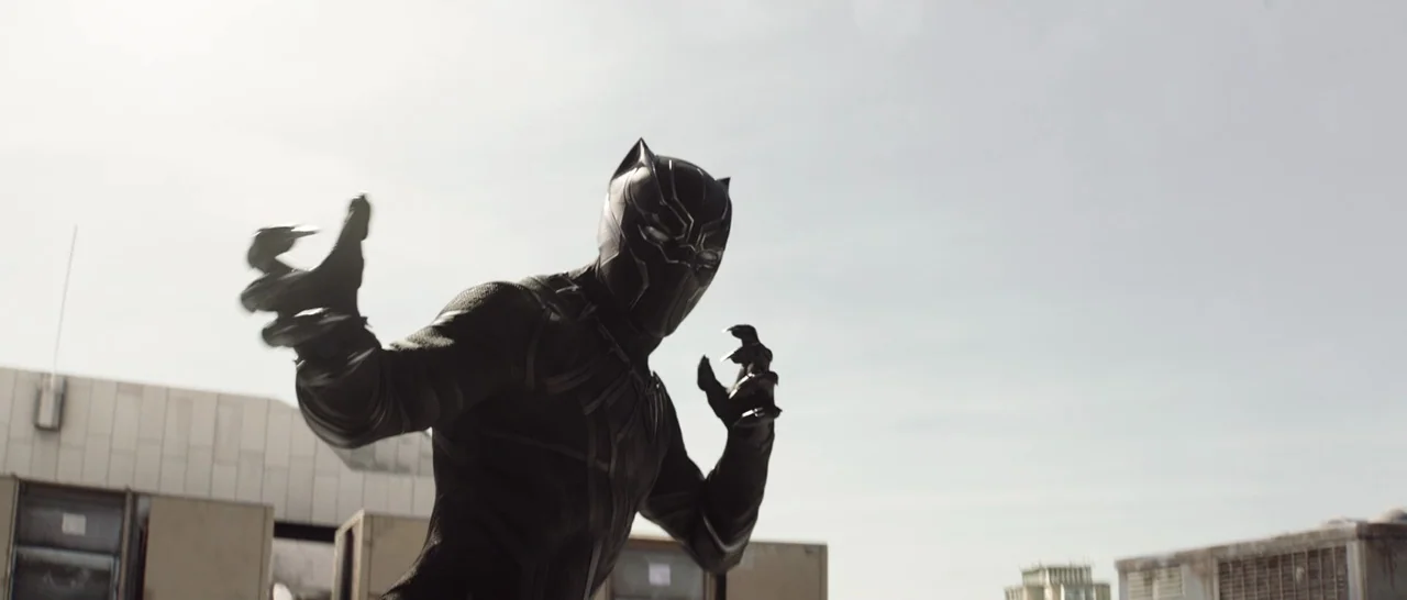 Captain America: Civil War (2016) movie still: medium — The subject stands on an industrial building top under a bright overcast sky. The costumed…