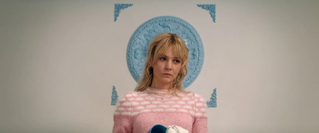 Promising Young Woman (2020) movie still: medium — A plain white wall features a light blue circular decorative molding piece at center. A woman…