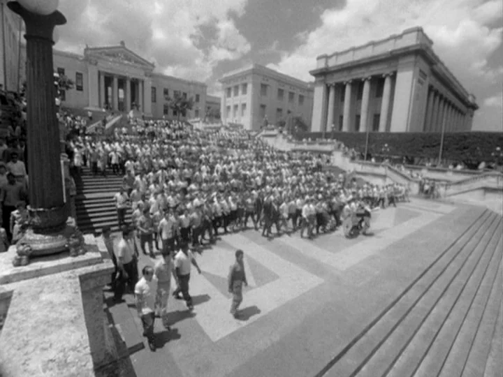 I Am Cuba (1964) movie still: wide — A large outdoor plaza features wide stone steps and classical neoclassical administrative buildings. A dense…