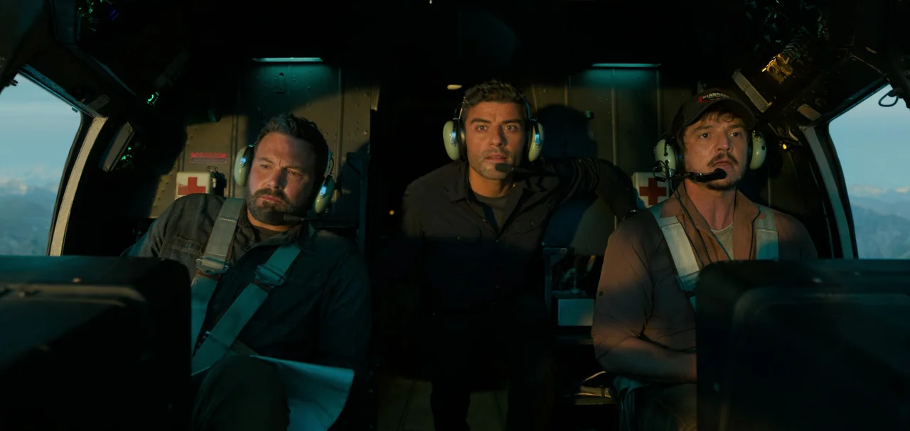 Triple Frontier (2019) movie still: medium — The interior of a helicopter cockpit shows three men sitting side by side. Sunlight hits the men from…
