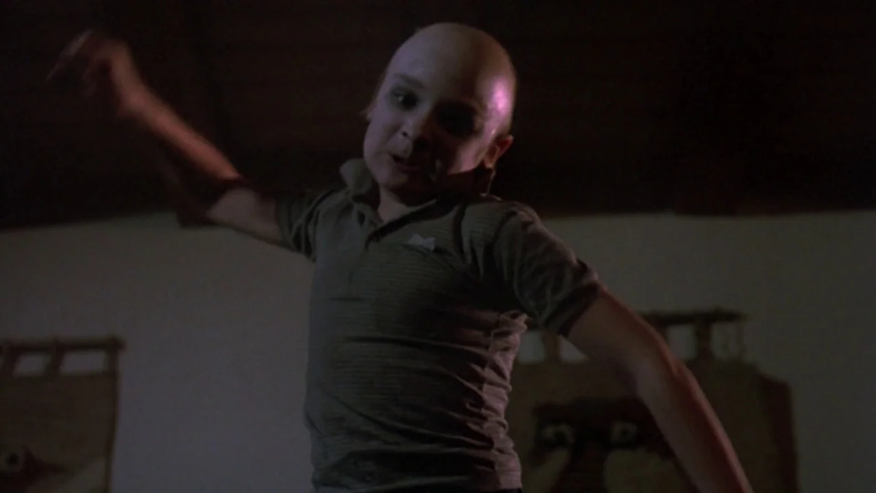 Friday the 13th: The Final Chapter (1984) movie still: medium — A dark, wood-paneled attic space contains indistinct hanging decorative objects on…