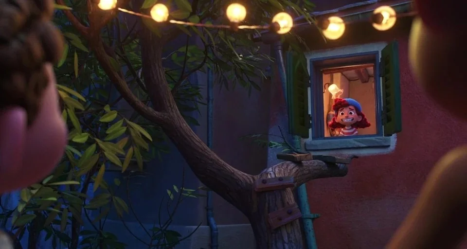 Luca (2021) movie still: medium — A small residential exterior at night features a tree with rustic wooden step boards. A young girl with red hair…