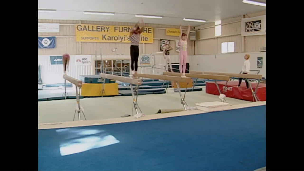 At the Heart of Gold: Inside the USA Gymnastics Scandal (2019) movie still: wide — A spacious training facility features multiple wooden balance…