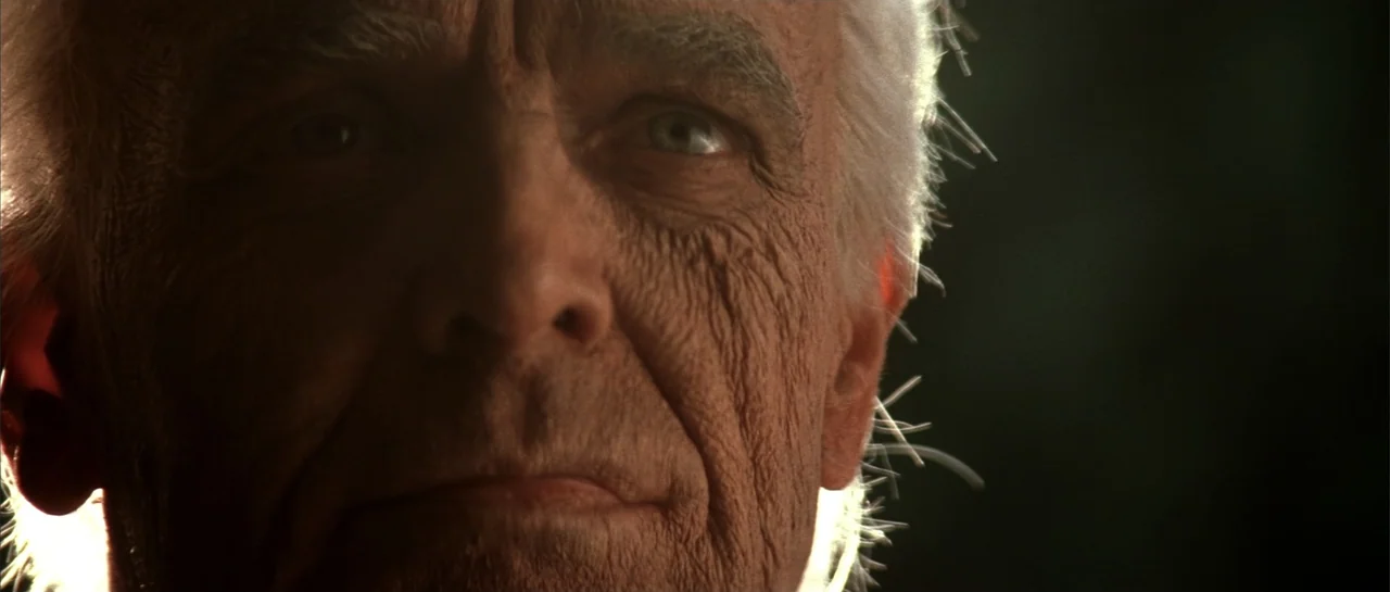 Jeepers Creepers 2 (2003) movie still: closeup — A close view of an elderly man's face in high contrast lighting. The subject faces the camera…