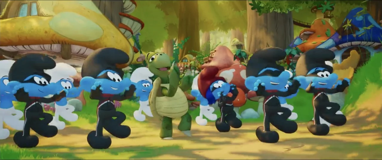 Smurfs (2025) movie still: medium — A whimsical woodland village features large mushroom-shaped houses under a dense leafy canopy. Multiple Smurfs…