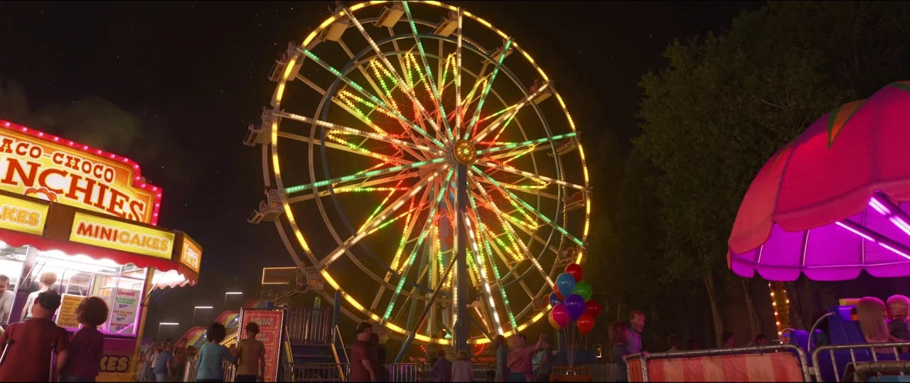 Toy Story 4 (2019) movie still: establishing — A nighttime scene at a fairground features a large ferris wheel illuminated with yellow, red, and…