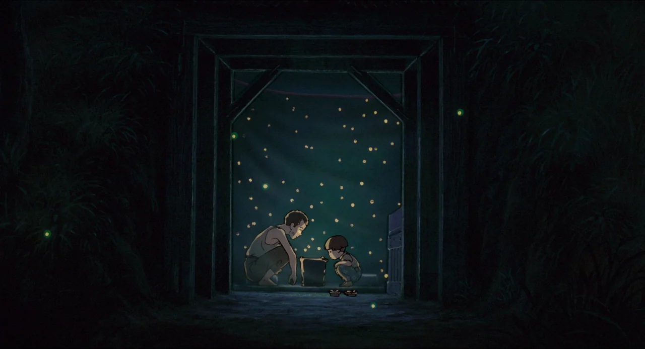 Grave of the Fireflies (1988) movie still: wide — A dark, wood-framed entranceway is surrounded by dense, shadowy vegetation at night. Two people…