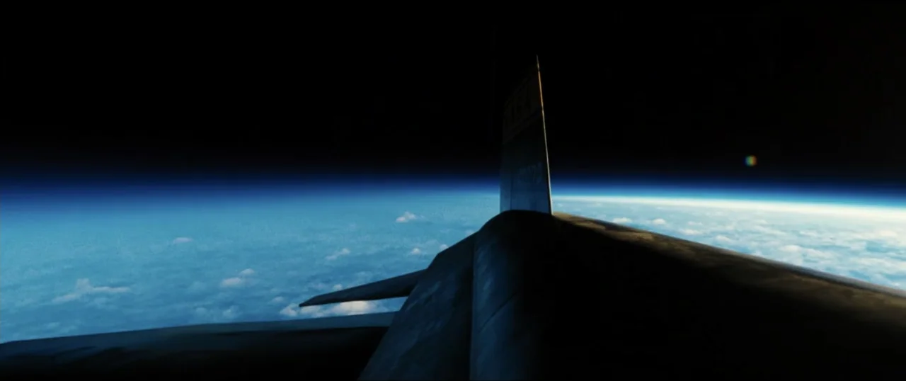 First Man (2018) movie still: wide — The view from the tail of a high-altitude aircraft shows the curve of the earth. Thin atmosphere and thick…
