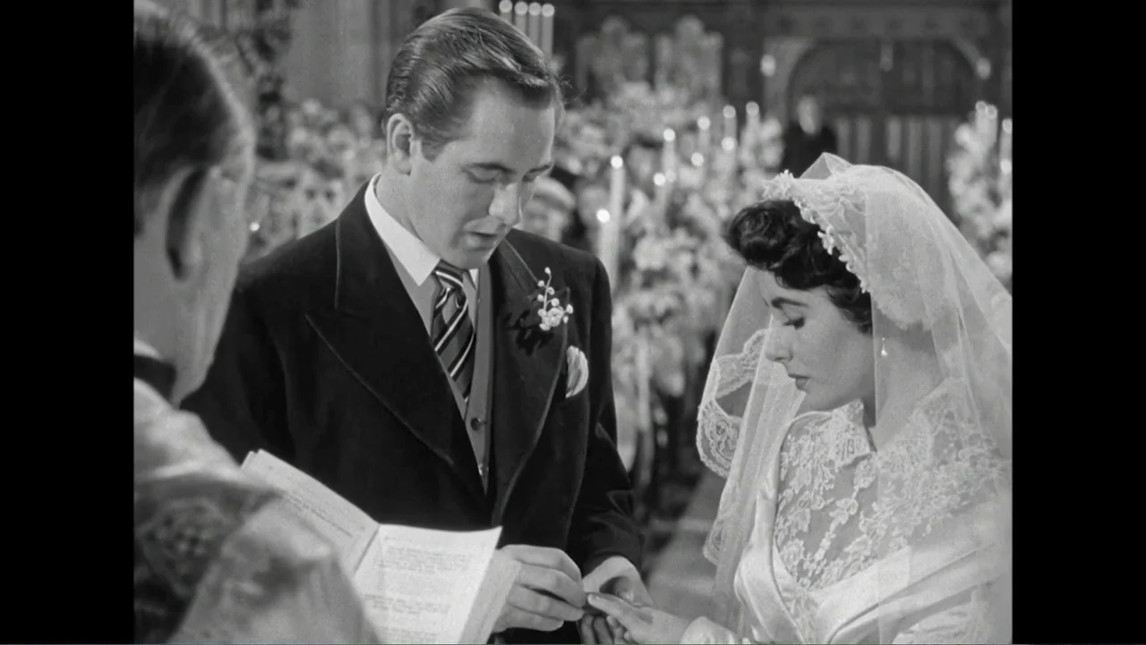 Elizabeth Taylor: The Lost Tapes (2024) movie still: medium — A church interior with a bridal couple standing before a priest during a wedding. The…