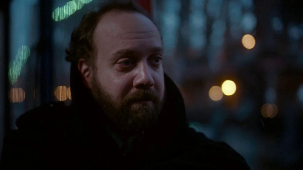 Cold Souls (2009) movie still: closeup — A man stands on a dark city street at night with blurry streetlights behind. He is looking off to the side…