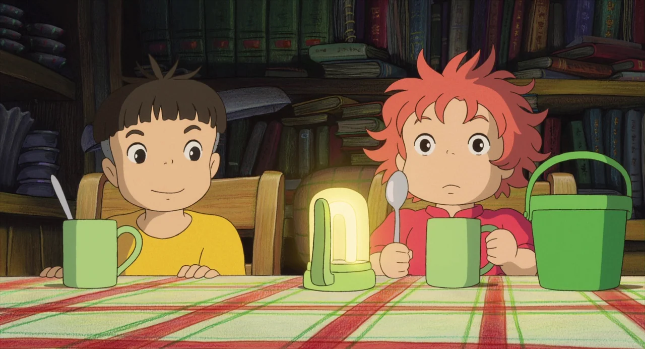 Ponyo (2008) movie still: medium — A wooden table with a plaid tablecloth holds two green mugs and a lantern. The two children sit at the table in…