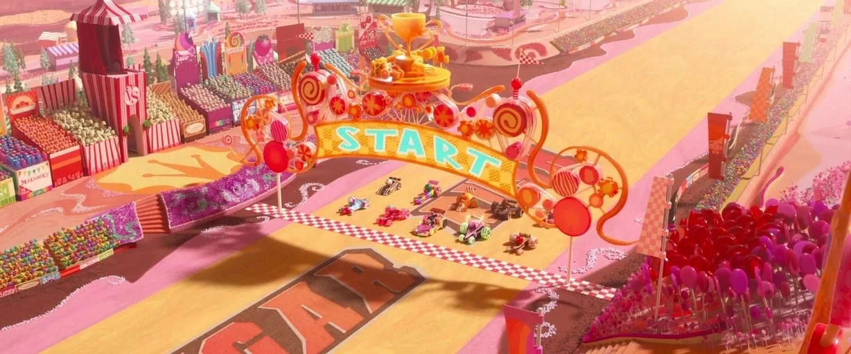 Ralph Breaks the Internet (2018) movie still: establishing — A colorful candy-themed race track features a large start gate with a gold trophy.…