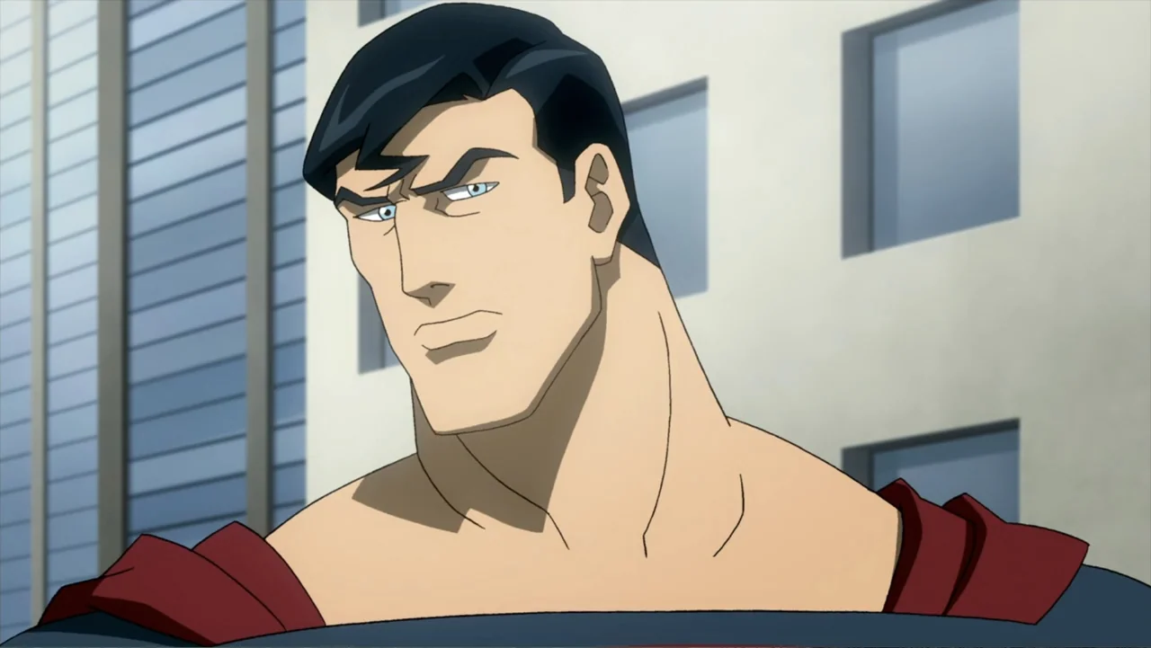 Superman/Shazam!: The Return of Black Adam (2010) movie still: closeup — A muscular man with black hair stands against a simple modern building…
